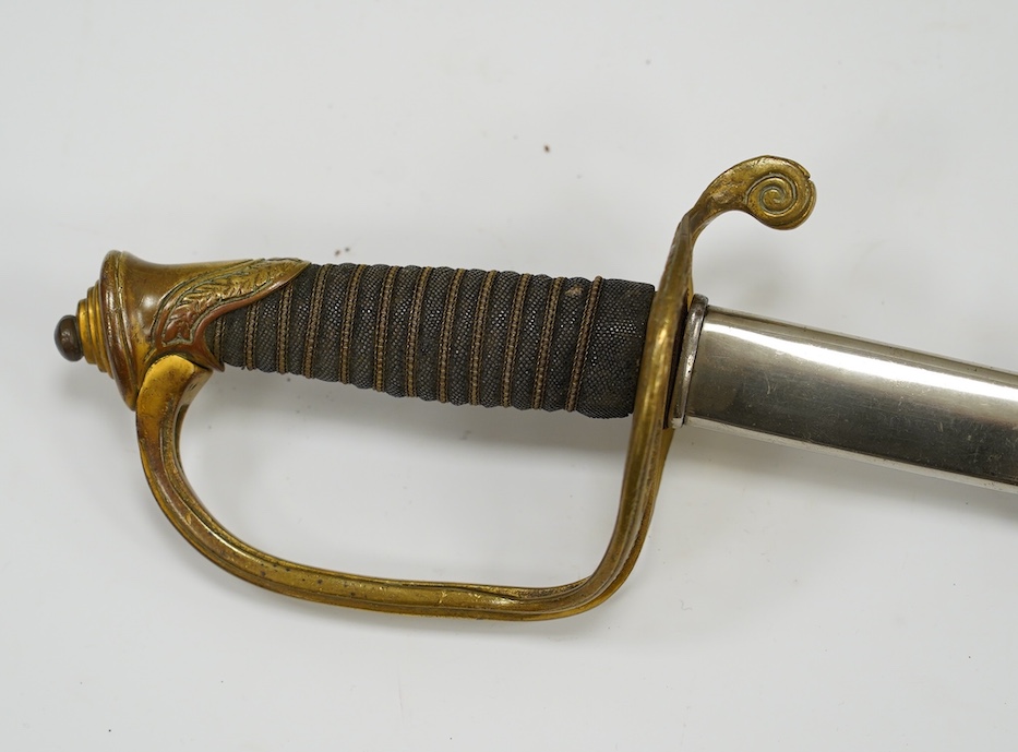 A 1954 US Marine Wilkinson Sword belonging to Staff Sergeant James Devereux 2nd believed to be son of General Devereux, etched blade, regulation brass hilt, in its plated scabbard, blade 76.5cm. Condition - good